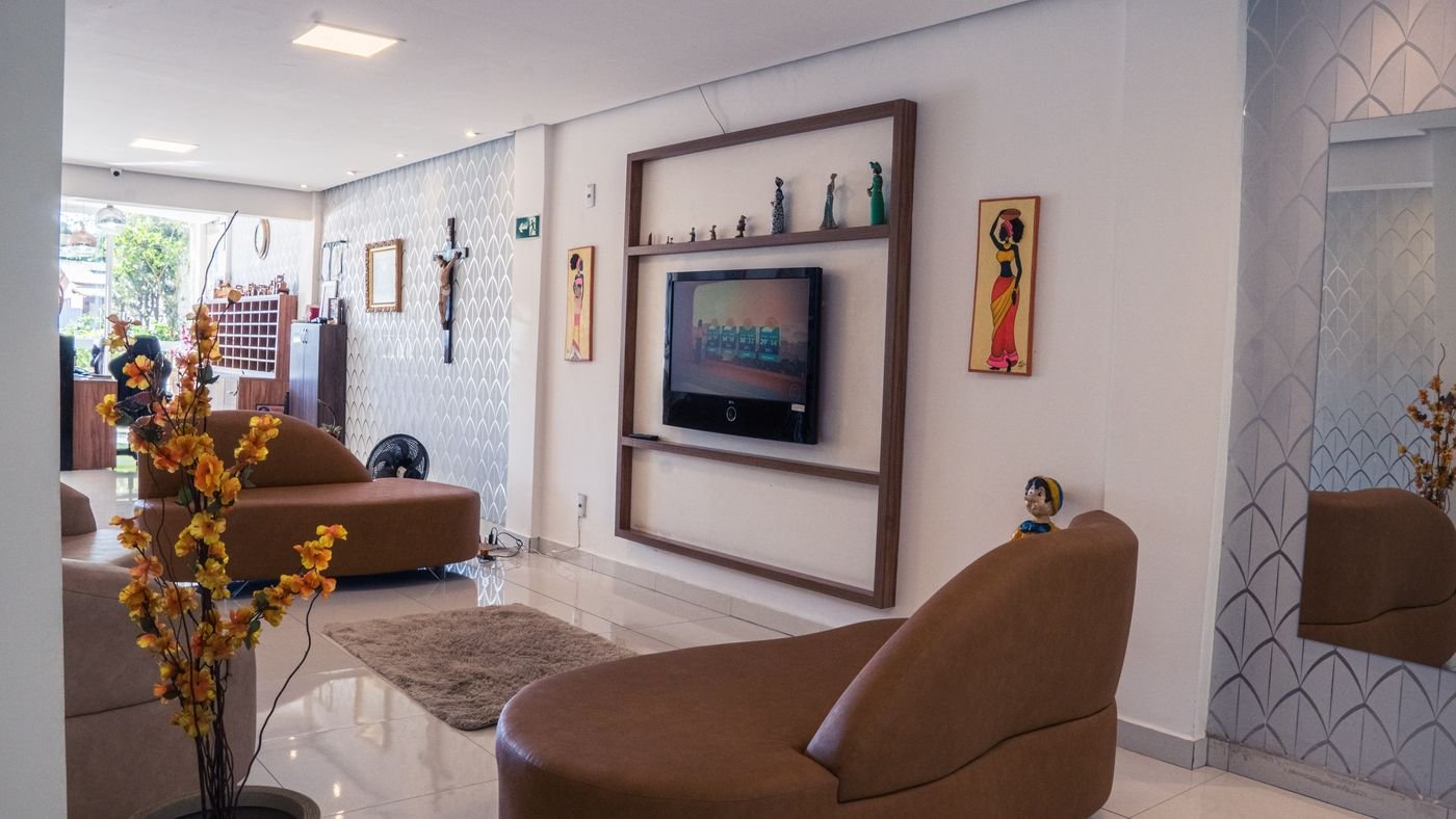 Sala de estar com TV e poltronas do Hotel Katraca Palace